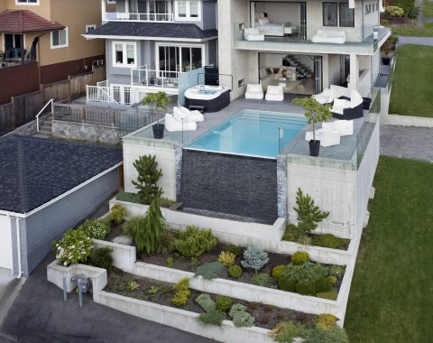 Arial view of the home showcasing the infinity pool and water wall