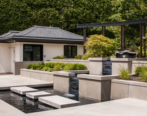 Outdoor swimming pool water feature with stepping stones