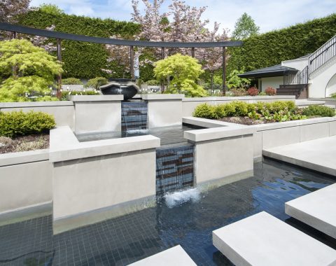 Outdoor pool renovation with water features