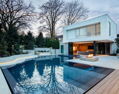 Recognized as a Grand International Excellence Award winner, this luxury flood edge pool stands at the pinnacle of global pool design. Its dramatic, unique form—seamlessly blending graceful curves with crisp straight angles—is finished in a deep blue plaster and elegantly framed by a refined grey tile band.