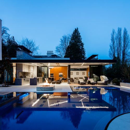 Night time show of the large pool with seamless outdoor living