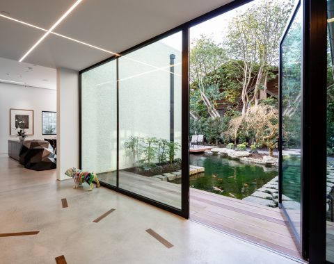 Gorgeous nano doors and rustic wooden elements in the home seamlessly blend the outdoors to the indoors.