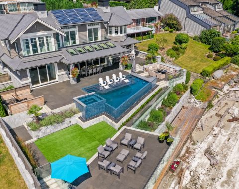View of full outdoor area showcasing the infinity edge pools and all outdoor living areas