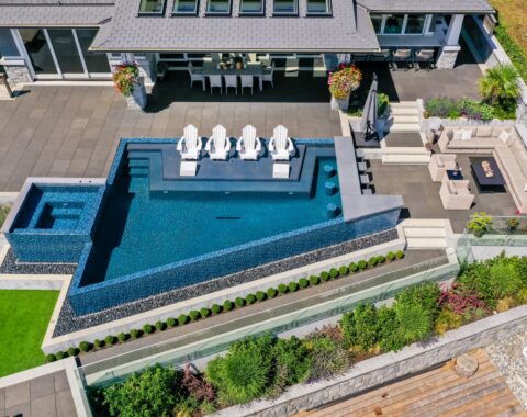 Full view of infinity edge pool with built in bar and sun lounge.