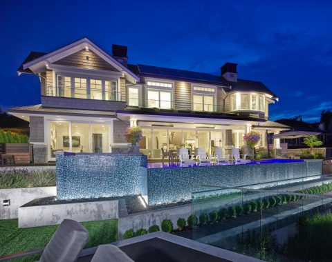 Gorgeous night time view of a mosaic blue finish infinity edge.