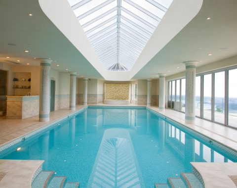 indoor swimming pool builders created a long pool with separate spa