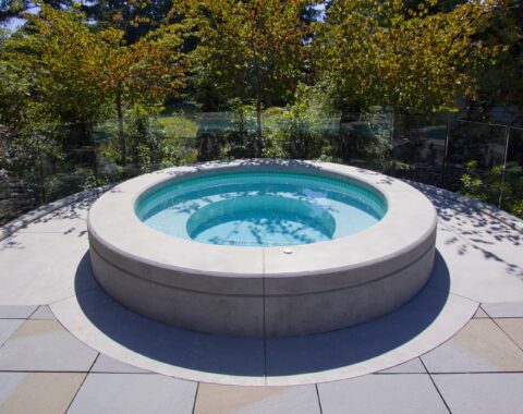 Circle hot tub and spa centered in a backyward space