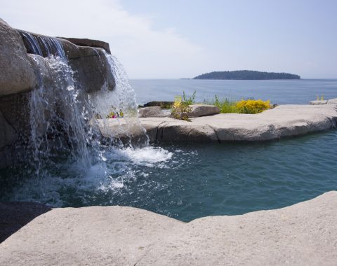 Natural swimming pool with water fall feature