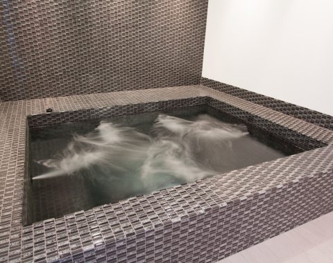 Indoor hot tub and spa with high pressured water jets