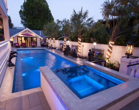 Large hot tub and spa with infinity style side creating water feature