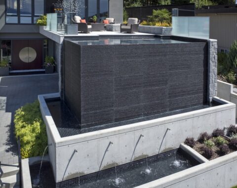 Infinity style cocktail pool built in with water feature in Burnaby, Vancouver and British Columbia