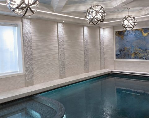 Indoor swimming pool builders created a integrated pool with dark colouring and built in spa