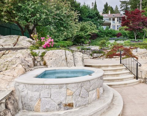 Natural built in spa surrounded by flowers and rocks