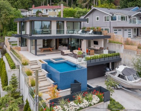 Modern home with large nano doors that bring the outdoors in, a steady flow between both spaces. At the heart, a majestic infinity edge pool with a 35'0