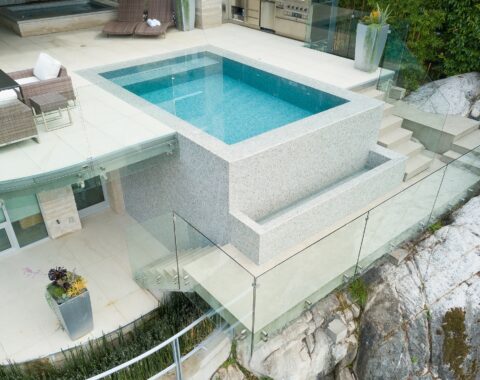 Aerial view of an infinity pool, showing the trough and lower deck area.