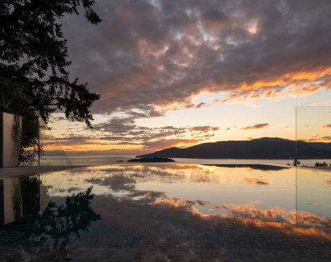 Sunset over a sleek infinity edge pool.