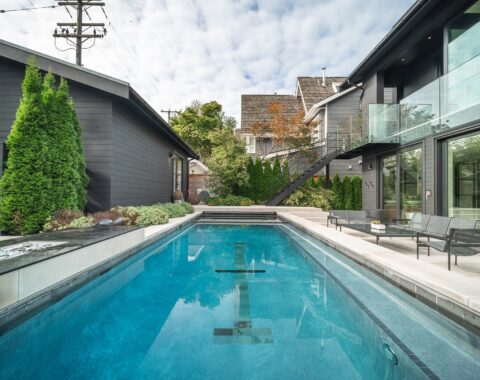 Luxurious lap pool with adjoining hot tub, ideal for upscale outdoor relaxation and fitness.