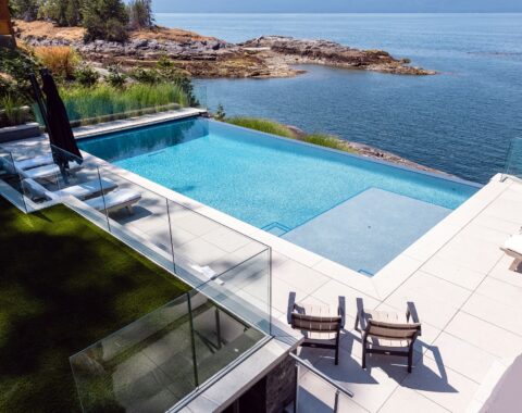 Beachfront property featuring an infinity pool with breathtaking ocean views, baja shelf for lounging and plenty of space for splash time!