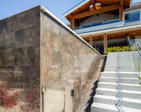 Image of this pool paradise with a waterfall feature and stairway.