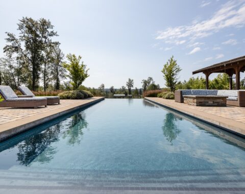 A relaxing poolside scene in a dream backyard oasis, perfect for leisure and fitness.