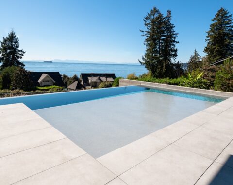 Enter a modern outdoor space with a clean design and scenic nature views, pool side view, featuring a minimalist style with Baja shelf and neutral tones—perfect for relaxing and enjoying nature.